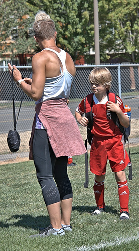 woman female lady mother blonde kid boy soccer