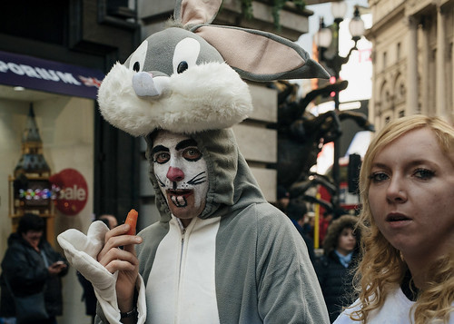 picadilly circus london west end man dressed up costume fancy dress rabbit bugs bunny eating carrot funny scene candid street image photo nikon d750